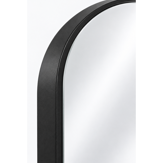Detail of arched top and powder-coated black frame on floor mirror
